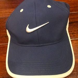 Nike dry-fit golf hat.  Navy blue and gray.  Velcro strap. One size fits all.